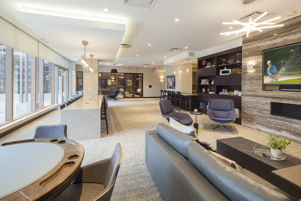 a large lobby with couches and chairs and a television