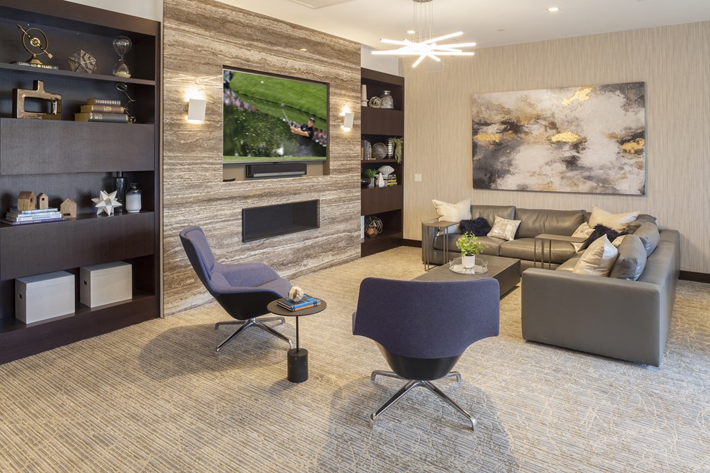 a living room with couches and chairs and a television