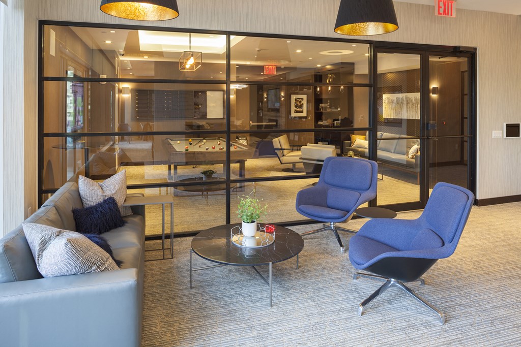 a living room with blue chairs and a table