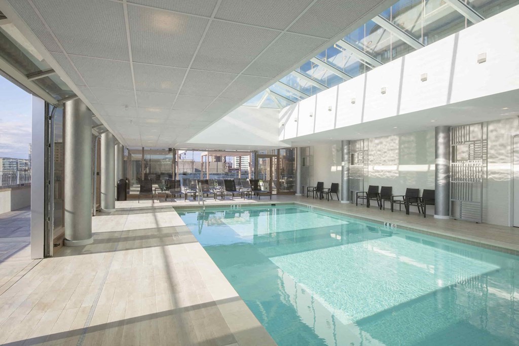 a swimming pool in the middle of a building with glass ceilings