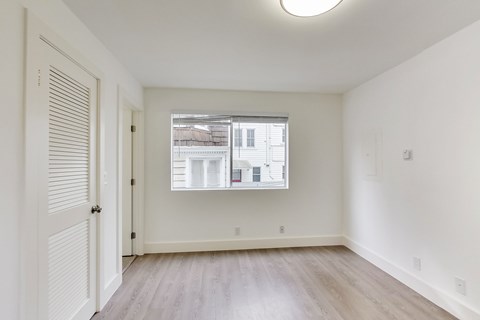 A room with a window and a door.