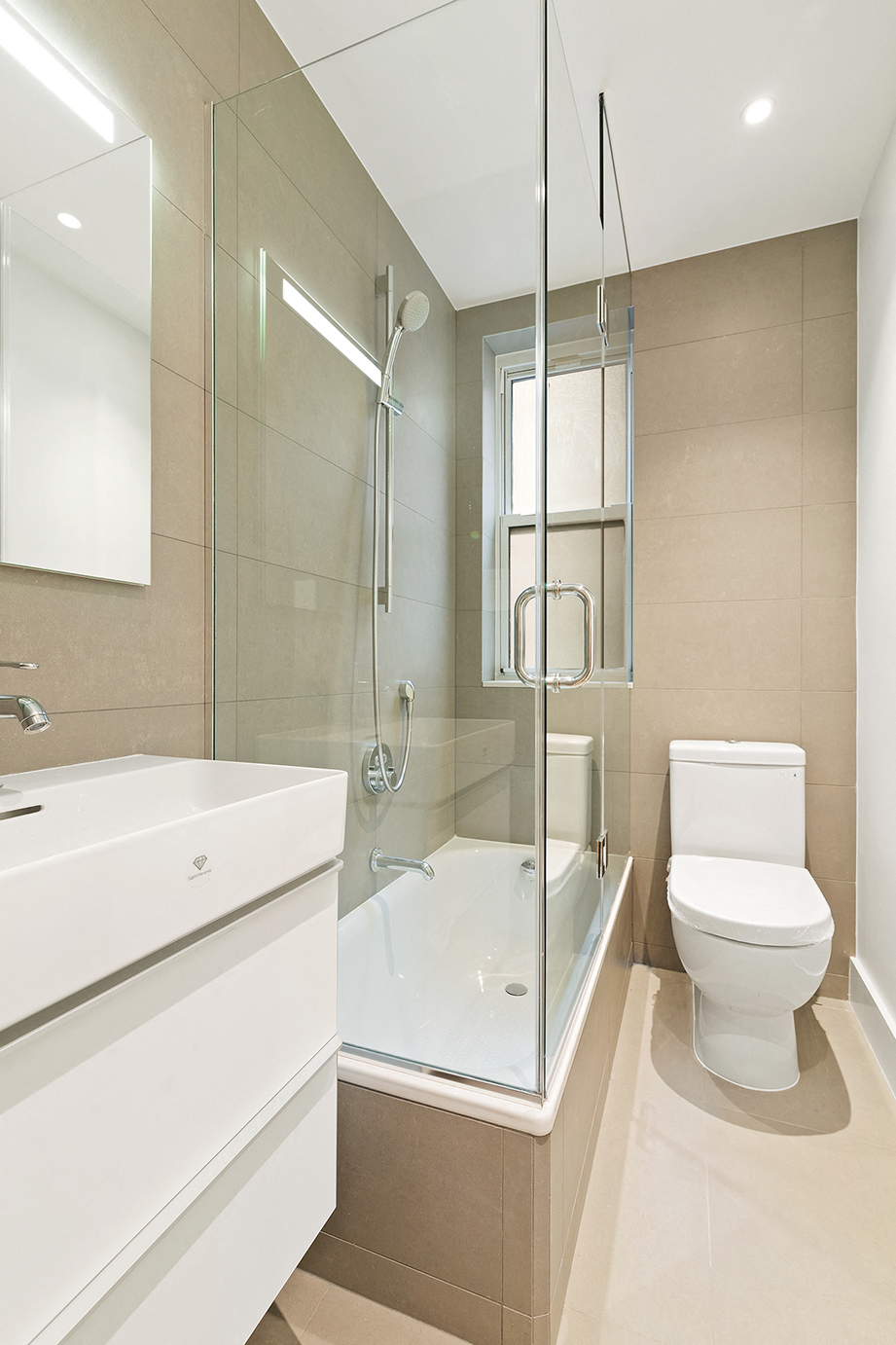 a bathroom with a shower toilet and sink