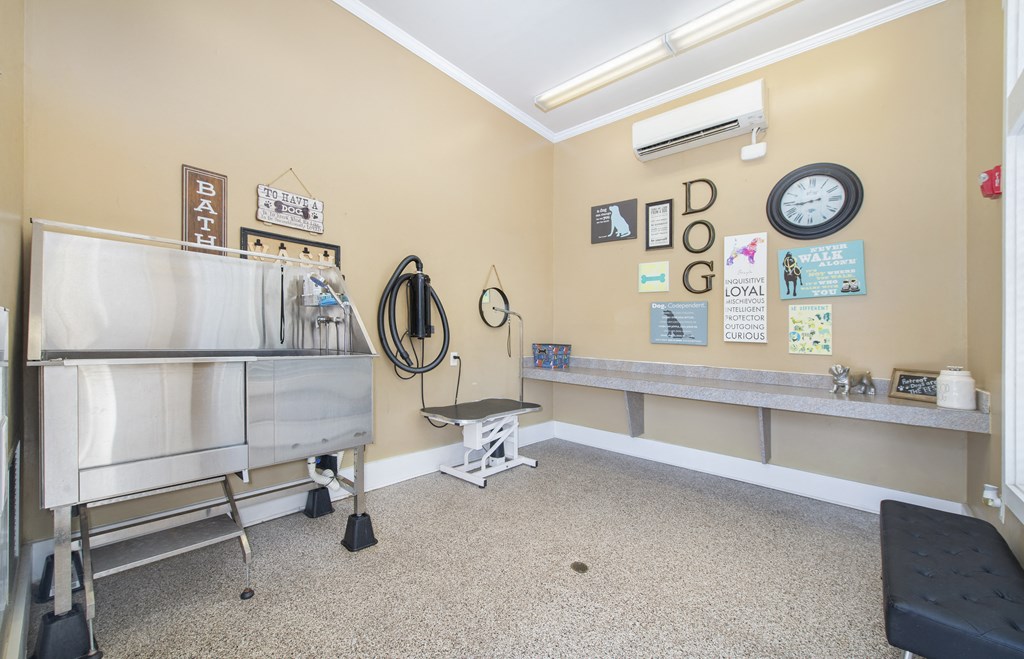 a room with a refrigerator and a counter and a clock on the wall