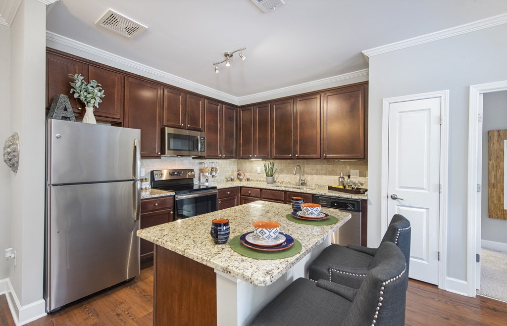 a kitchen with stainless steel appliances and a granite counter top