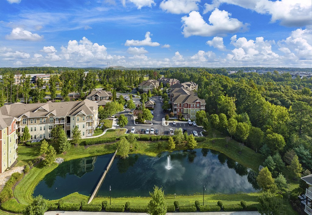 an aerial view of the resort with a lake and buildings