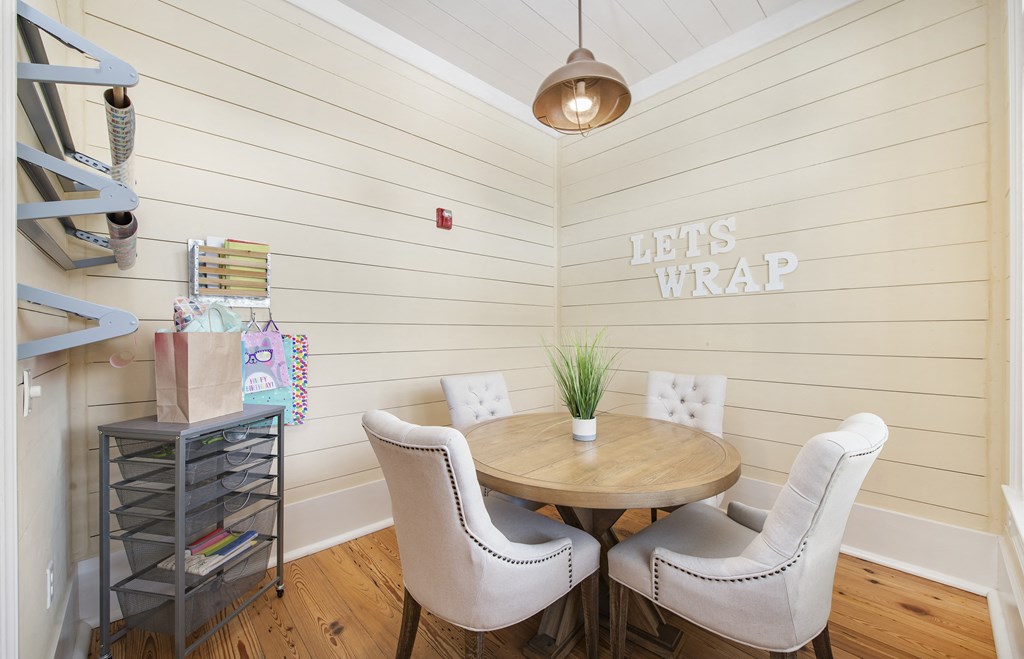 a dining room with white walls and a table and chairs