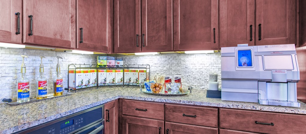 a kitchen with wood cabinets and a counter top and a sink