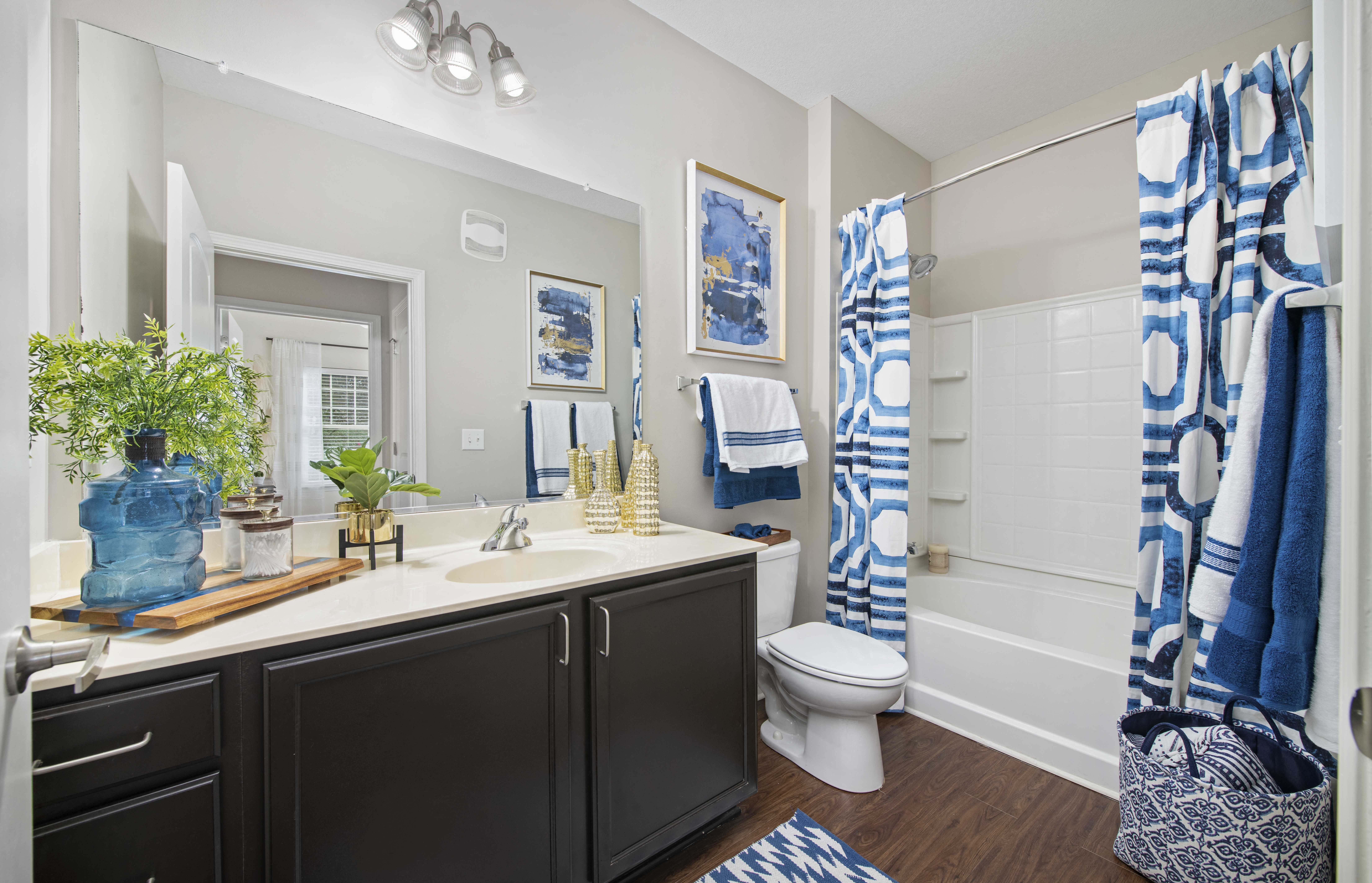 a bathroom with a sink and a shower and a toilet
