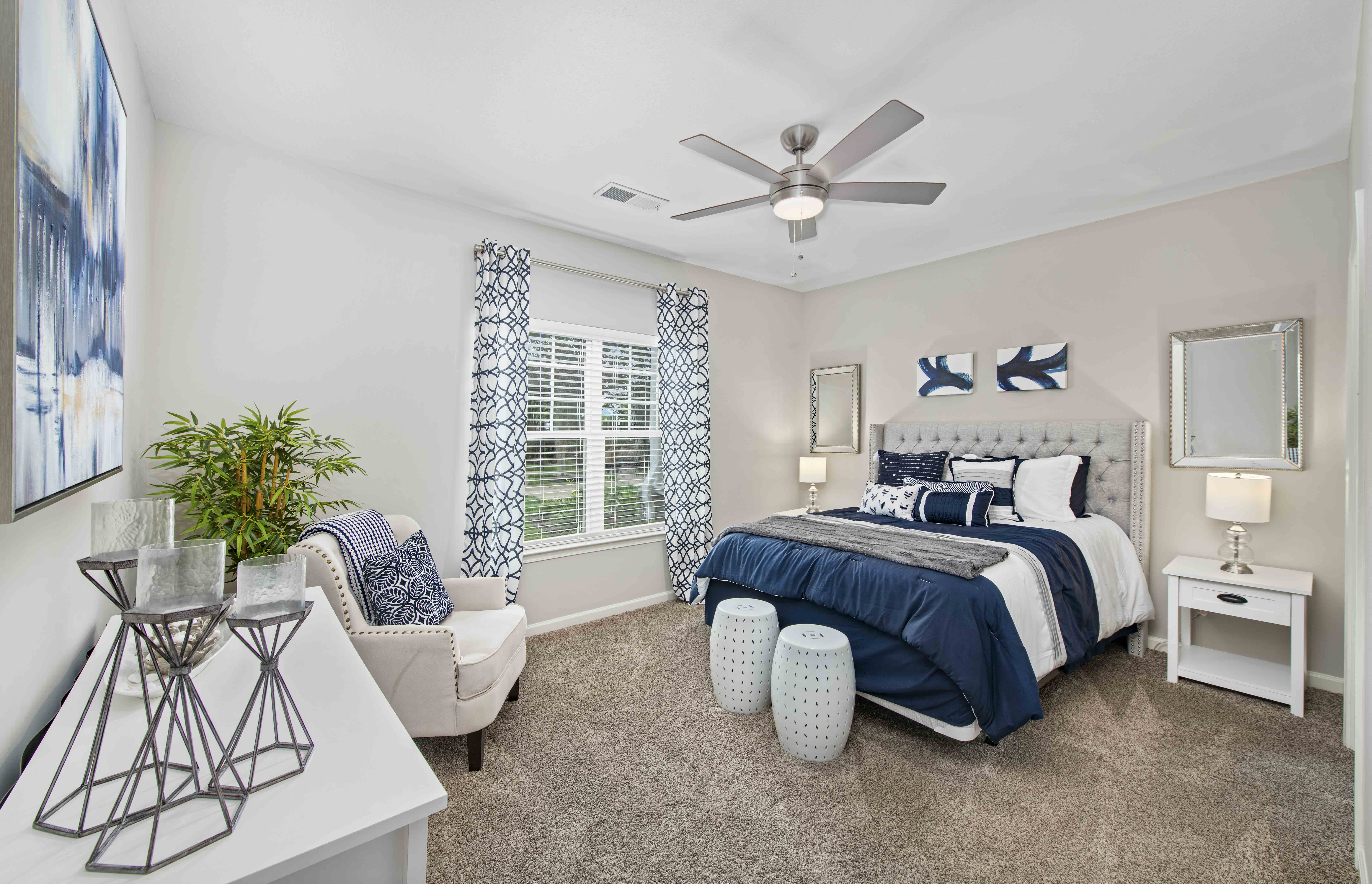 a bedroom with a bed and a ceiling fan