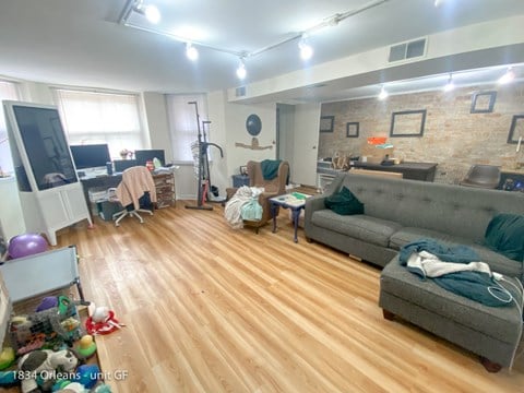 a living room filled with furniture and a wooden floor