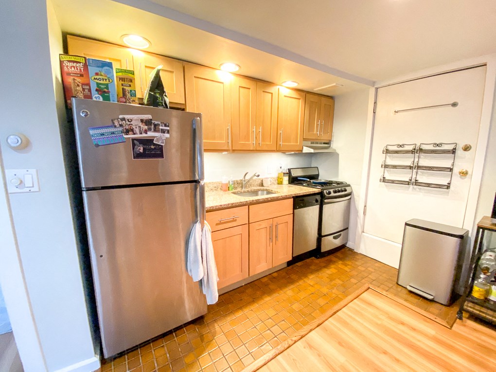 a kitchen with stainless steel appliances and wooden cabinets