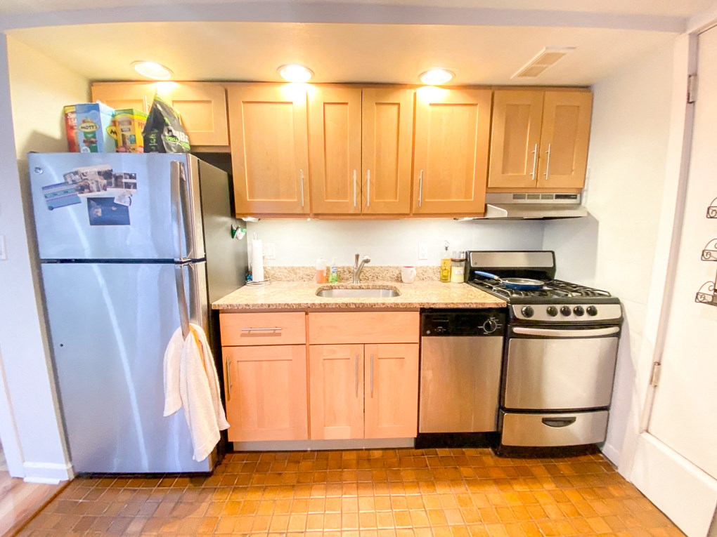 a kitchen with stainless steel appliances and wooden cabinets