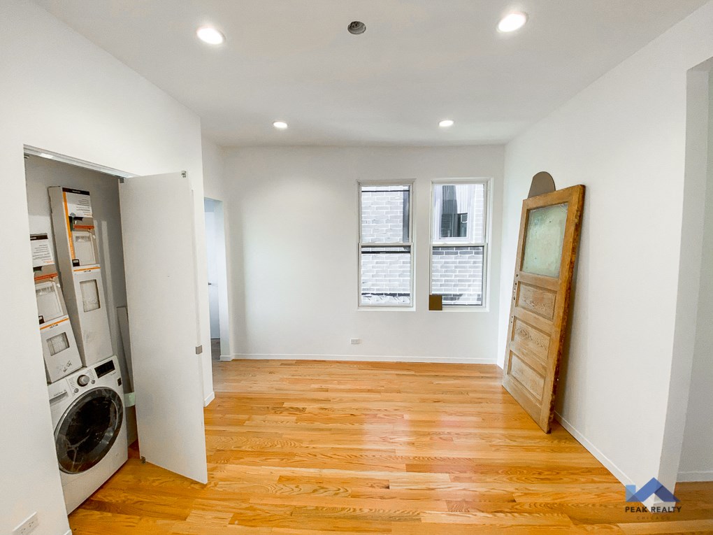a renovated living room with a washer and dryer in it
