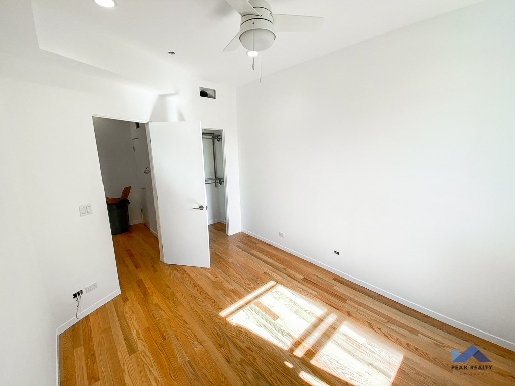 an empty living room with white walls and wooden floors
