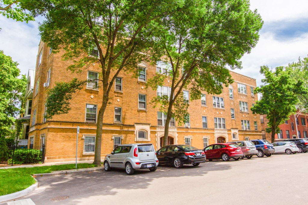 a large brick building with cars parked in front of it