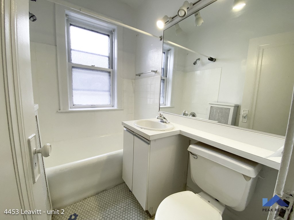 a bathroom with a sink toilet and a bath tub