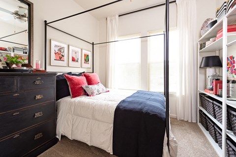 a bedroom with a bed and a dresser and a window