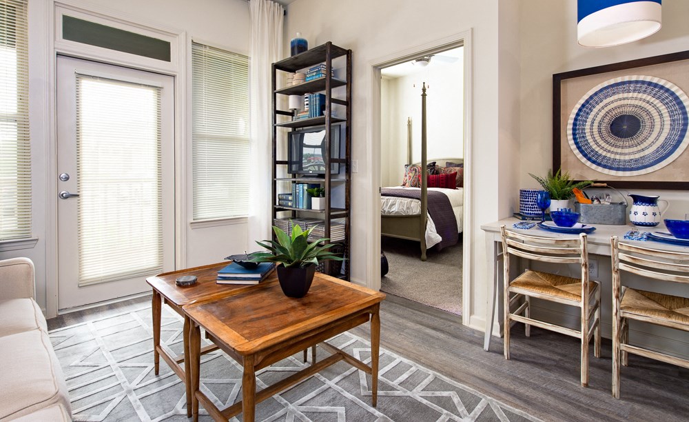 a living room and dining room with a table and chairs
