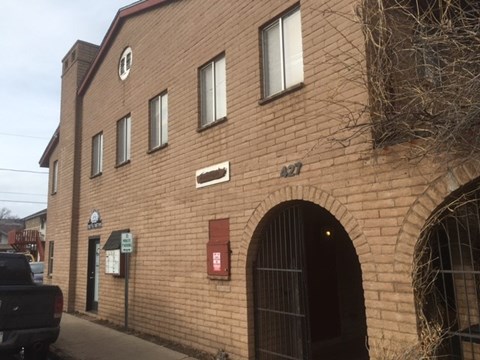 the front of a brick building with a gate