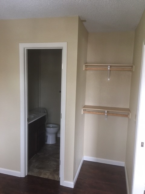a bathroom with a closet and a toilet in it