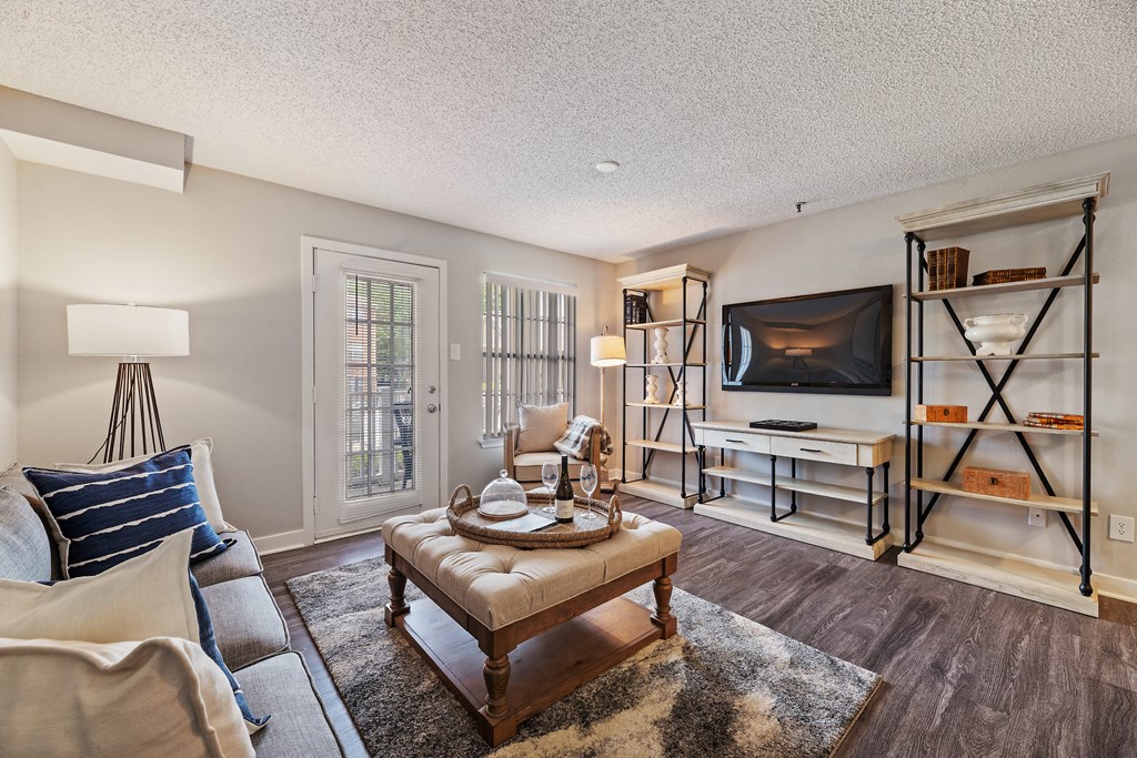 a living room with a couch and a chair and a television
