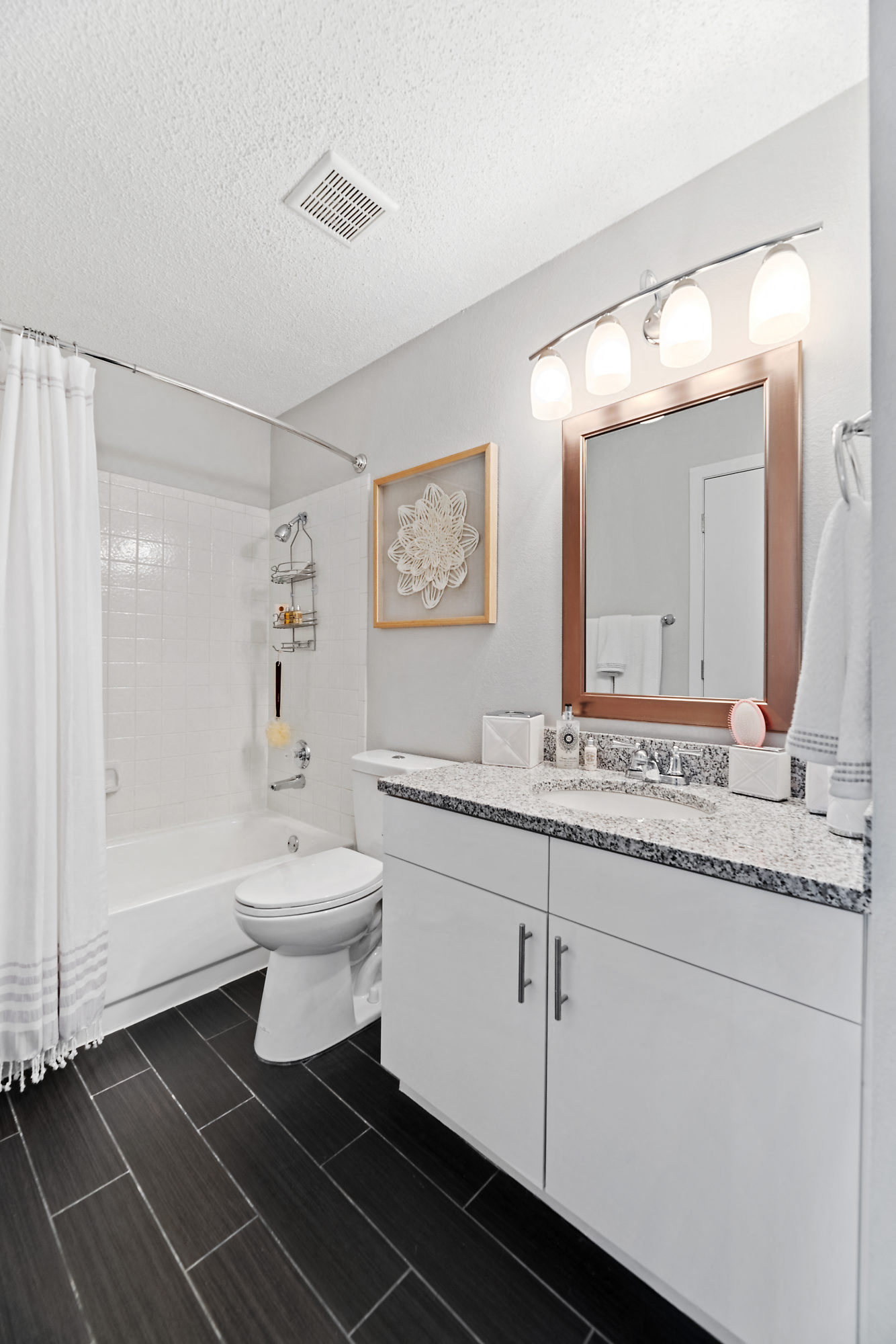 a bathroom with a sink and a toilet and a shower