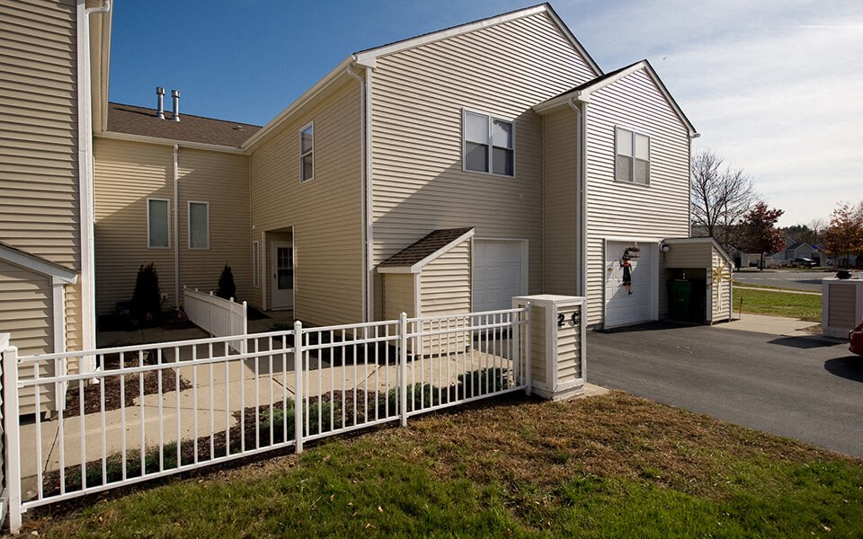 a house with a white fence in front of it