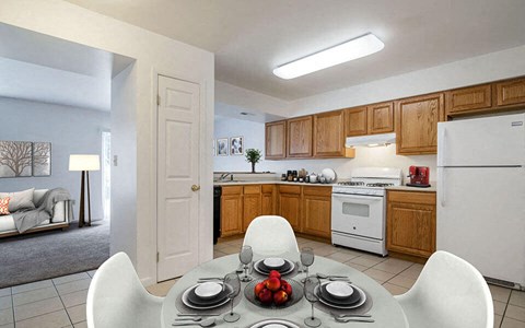 a kitchen and dining room with a table and chairs