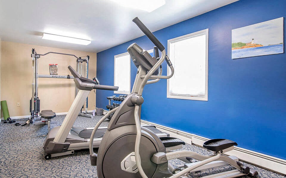a gym with cardio equipment at the apartments for rent