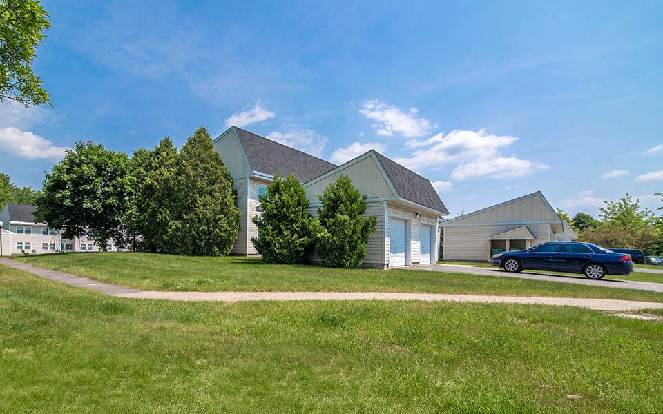 a blue car parked in front of a house