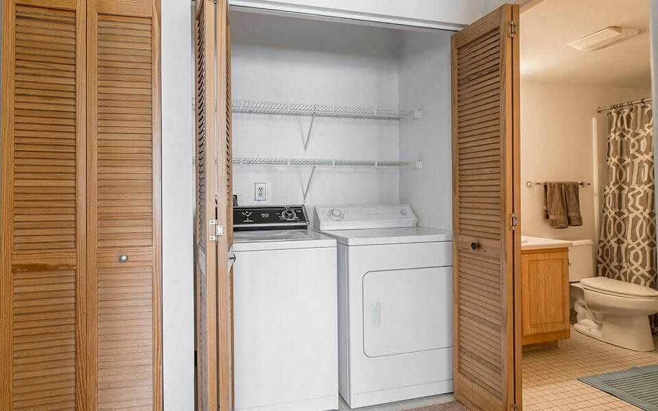 a bathroom with a washer and dryer in it