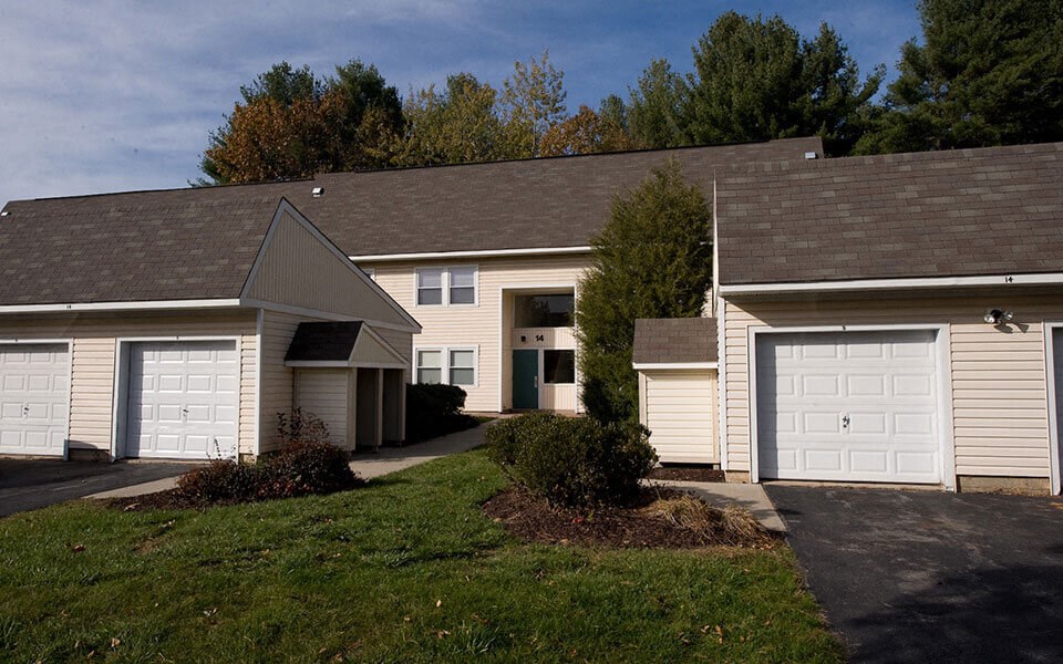 a house with two garage doors and a lawn