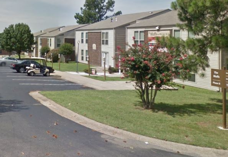 a car is parked in front of an apartment building