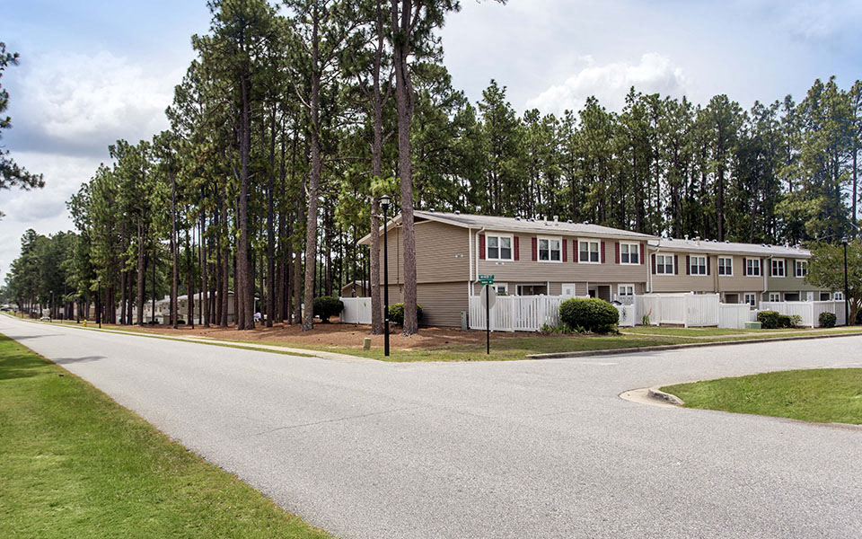 the view of an apartment building from the street