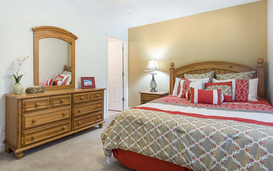 a bedroom with a bed and a dresser