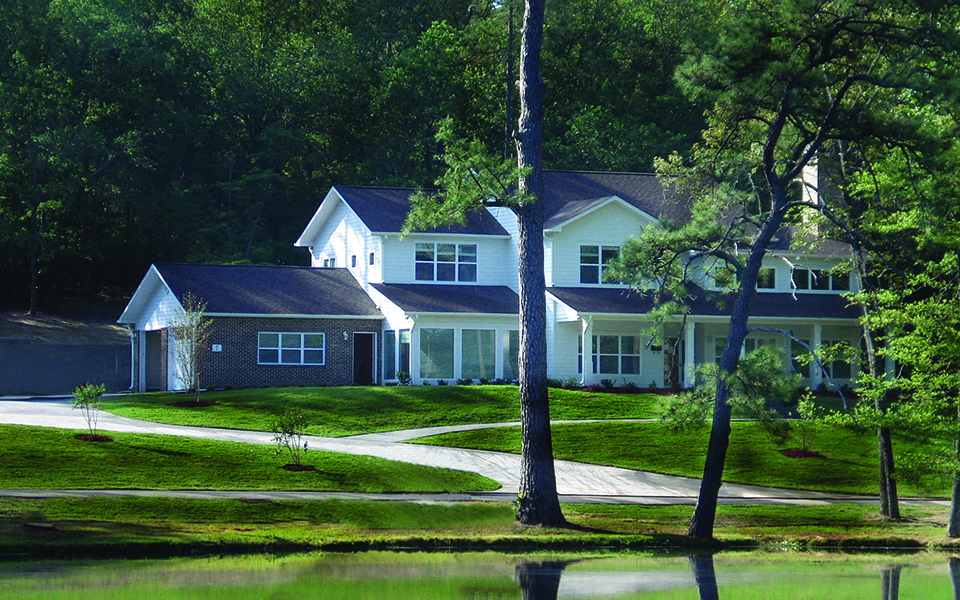 a house on the side of a body of water