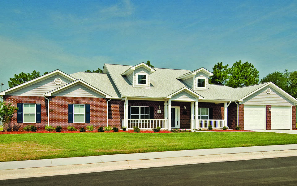 a house with a lawn in front of a street
