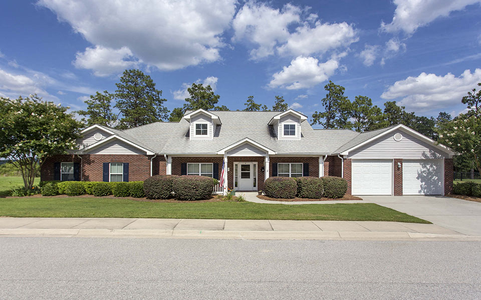 a house with a lawn in front of a street