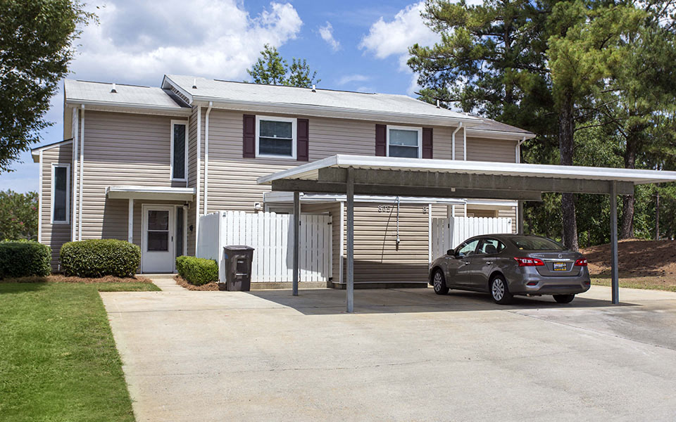 a car parked in a driveway in front of a house