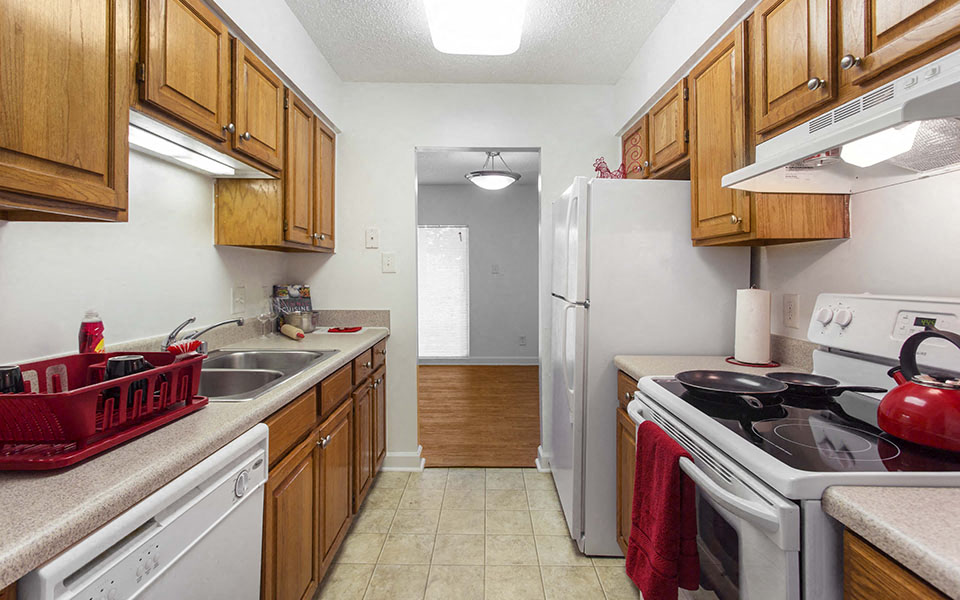 a kitchen with a stove refrigerator and a sink