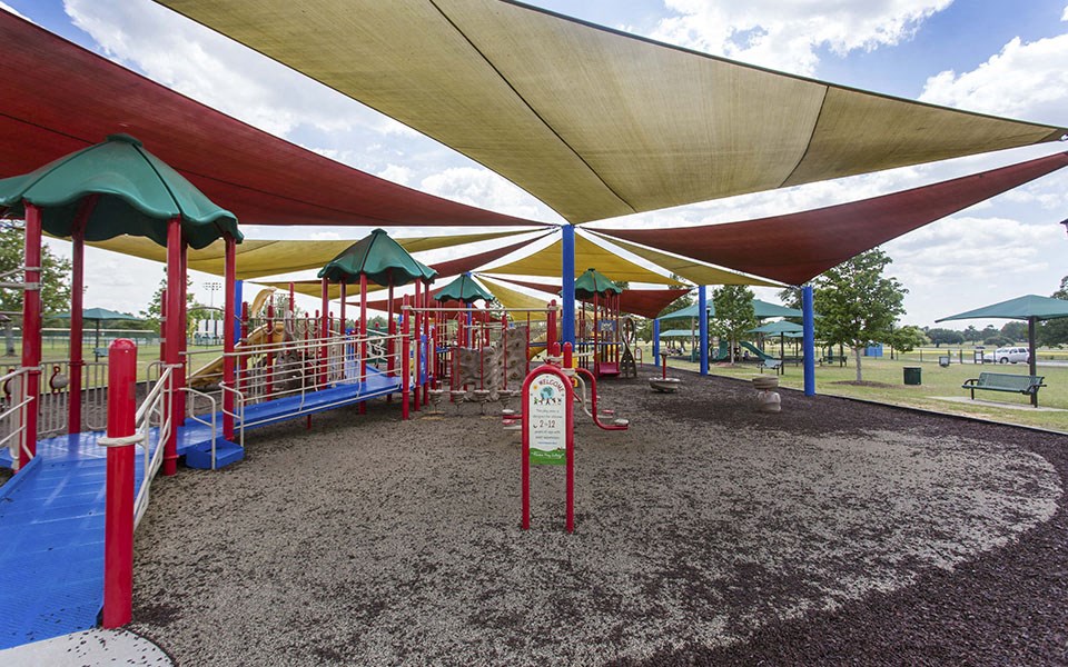 a playground at a park with shade structures