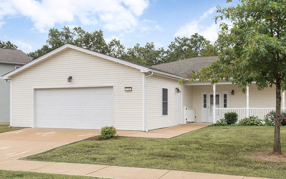 a white house with a driveway and a garage door