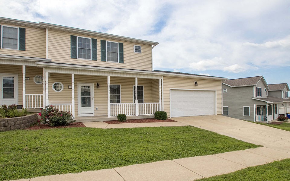 the front of a house with a driveway and a garage door
