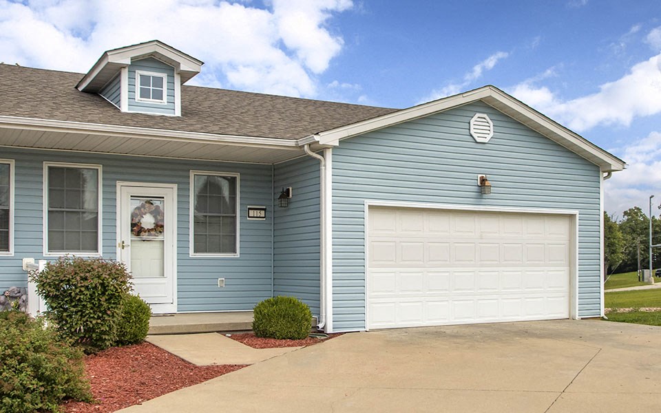 a blue house with a white garage door