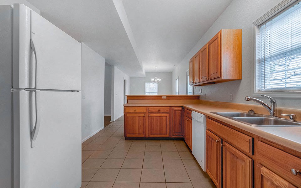a kitchen with a sink and a refrigerator