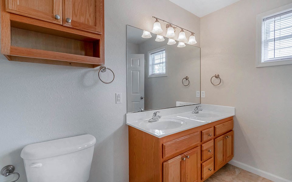 a bathroom with a toilet sink and a mirror