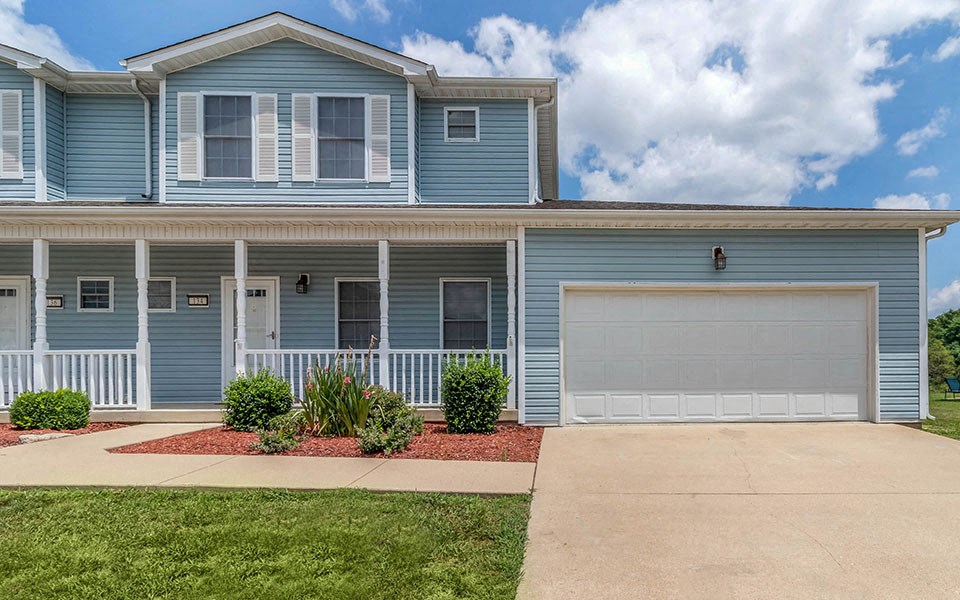 a blue house with a white garage door