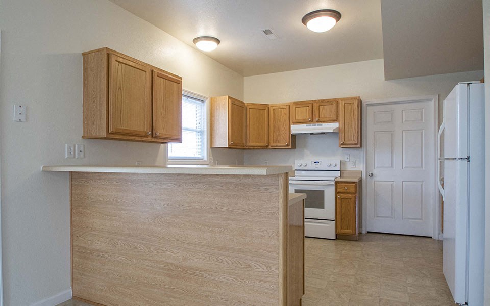a kitchen with wooden cabinets and a counter top