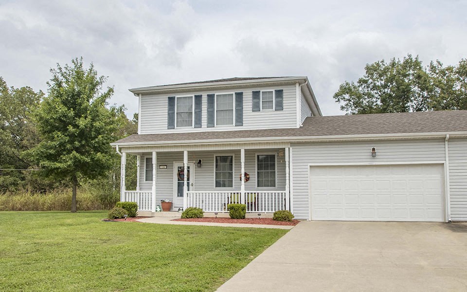 a white house with a driveway and a white garage door