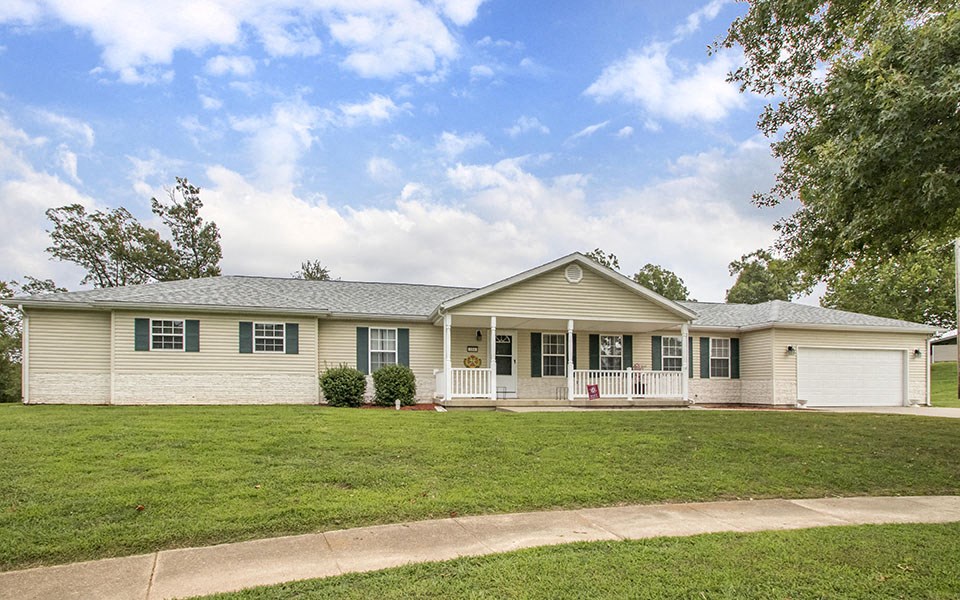 a white house with a lawn in front of it